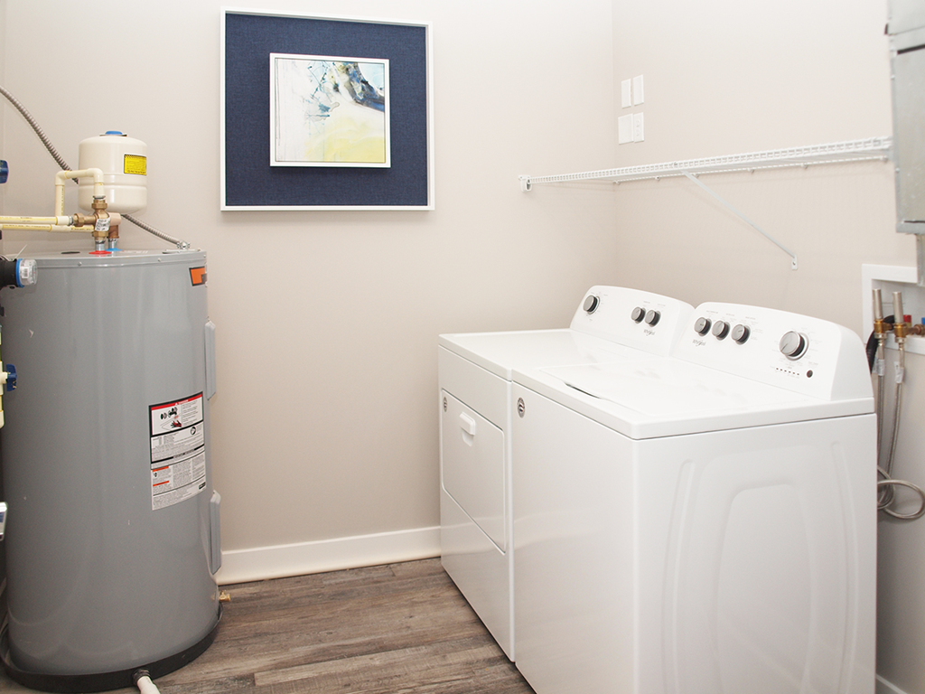 a washer and dryer in a laundry room with a water heater and a