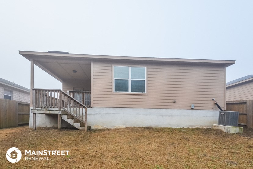 the exterior of a small house with a front porch and stairs