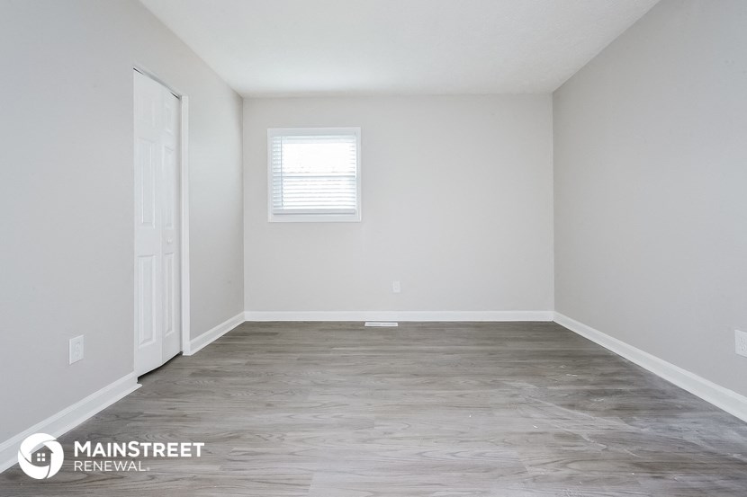 the interior of an empty room with white walls and a white door