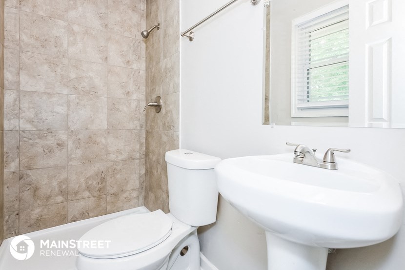 a bathroom with a sink and a toilet and a mirror