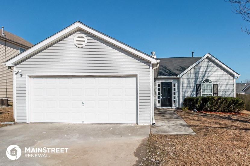 a white house with a white garage door