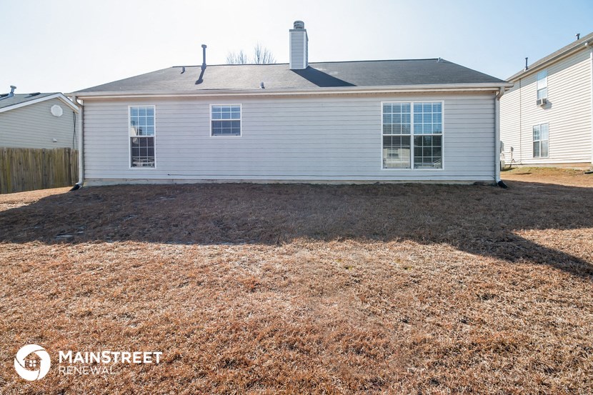 a white house with a yard in front of it