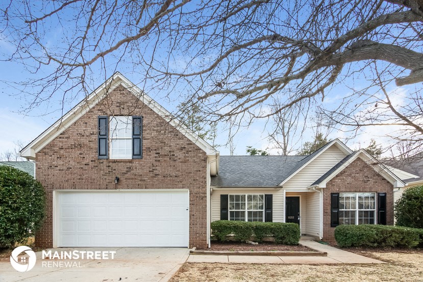 a home with a white garage door in front of it