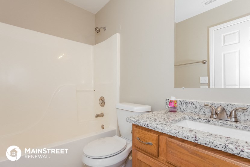 a bathroom with a toilet and a sink and a shower