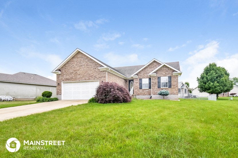 a brick house with a lawn in front of it