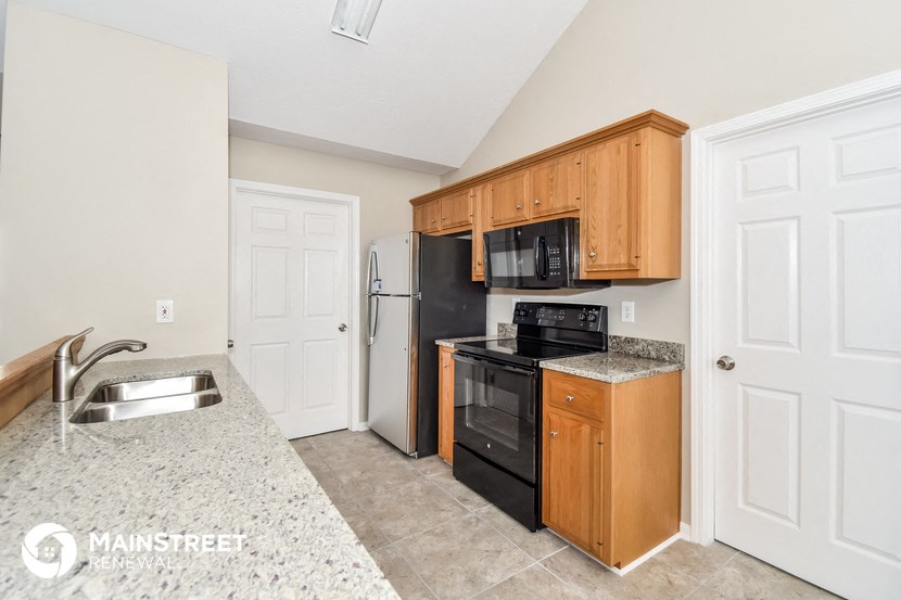 a kitchen with black appliances and wooden cabinets