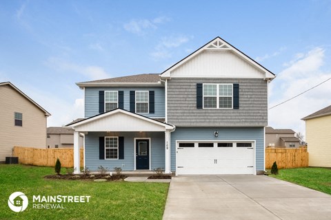 a blue house with a white garage door