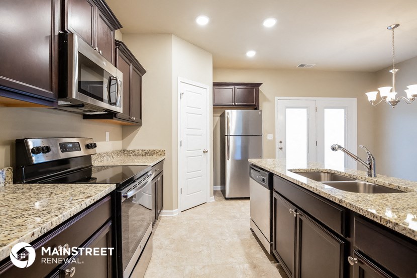 a kitchen with granite counter tops and stainless steel appliances