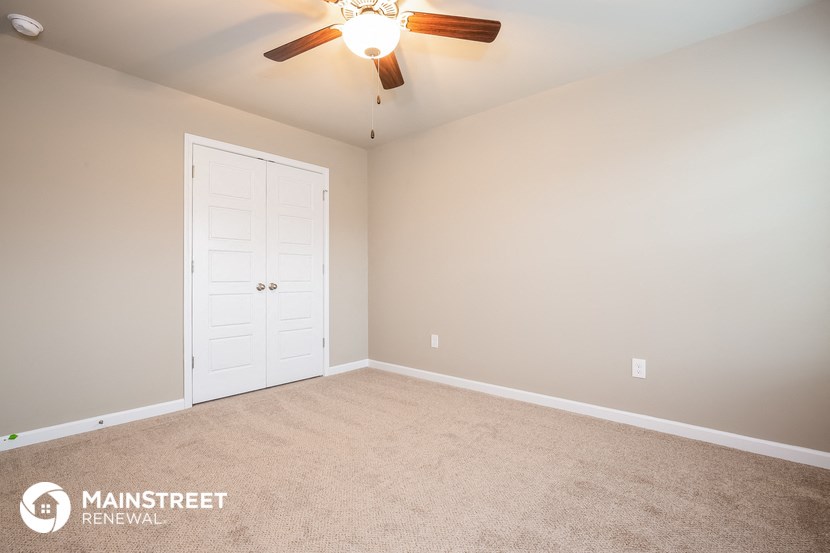 the master bedroom is spacious and has a ceiling fan