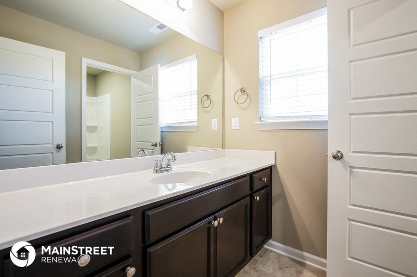 a bathroom with a large sink and a mirror