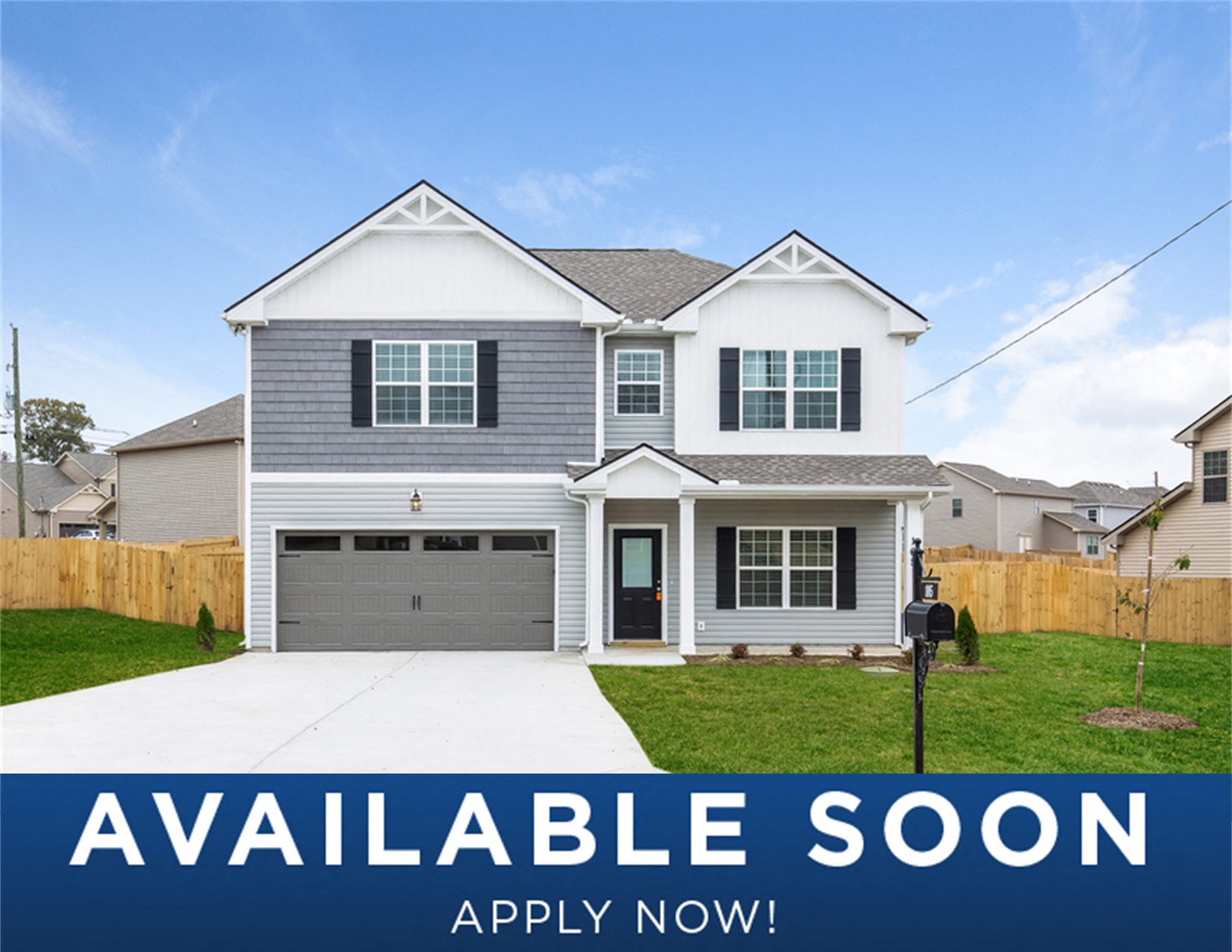 a white and gray house with a lawn and a driveway