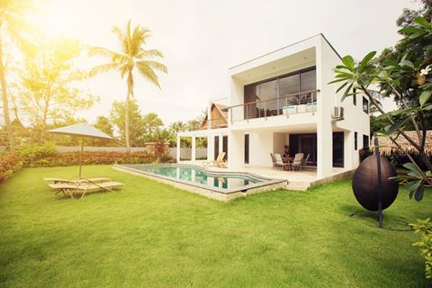 a villa with a pool and palm trees