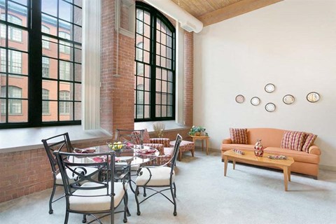 a living room with a table and chairs