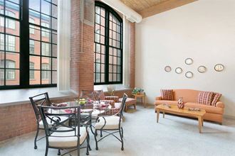 a living room with a table and chairs