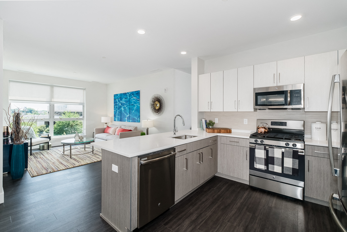 A modern kitchen with a large island and stainless steel appliances.