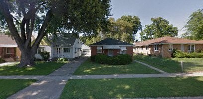 A tree in front of a house.