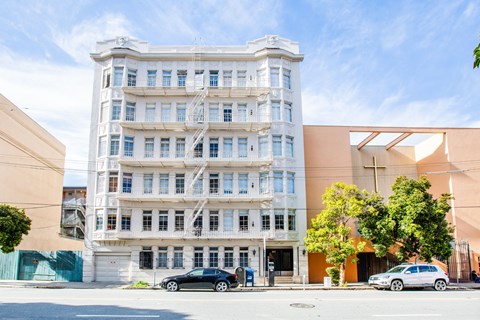 A white building with a blue sky in the background.