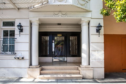 The front of a building with a black door and a number 250 on it.