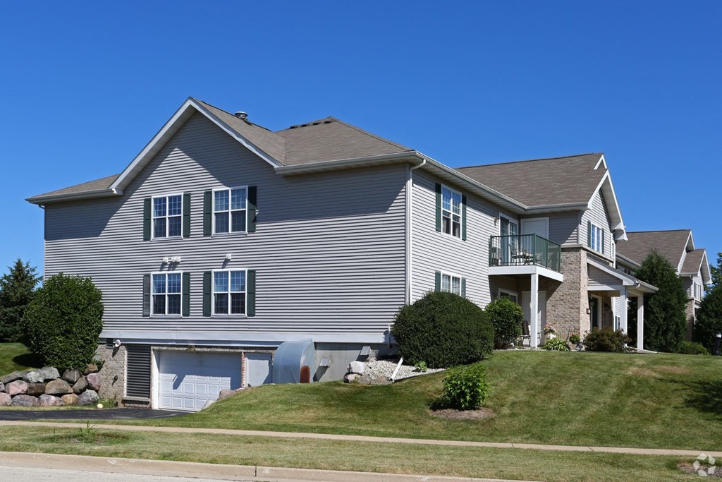 a house on a hill with a blue sky