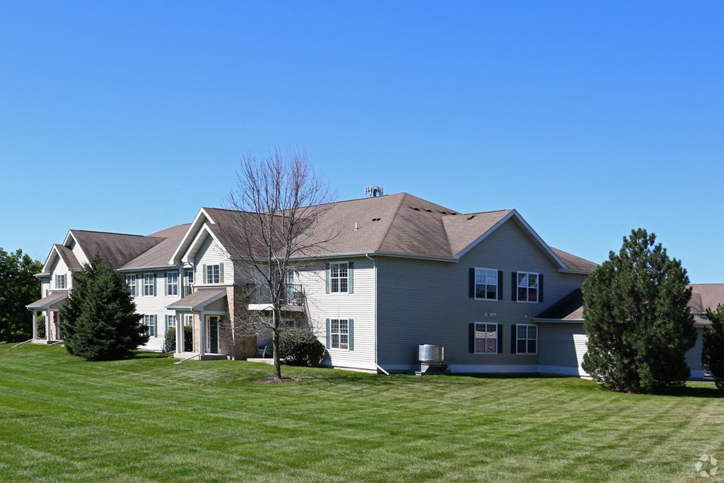 a large white house on a green lawn