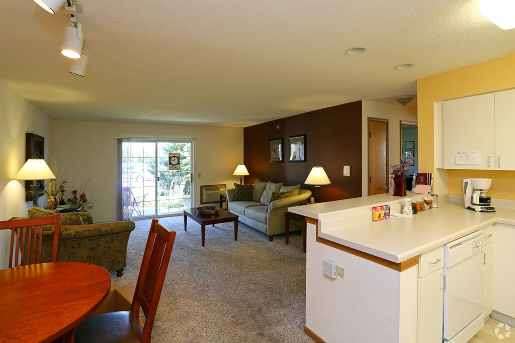 a living room with a kitchen and a dining room