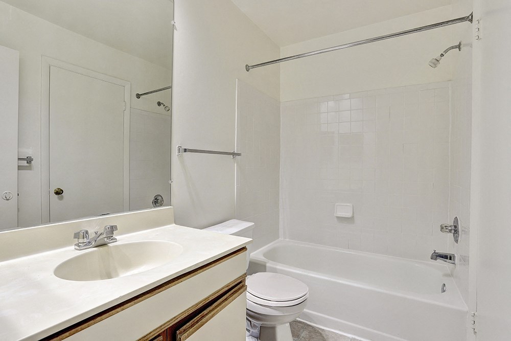 a bathroom with a sink toilet and a tub