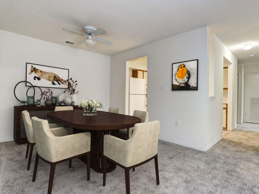 a dining room with a table and chairs and a ceiling fan