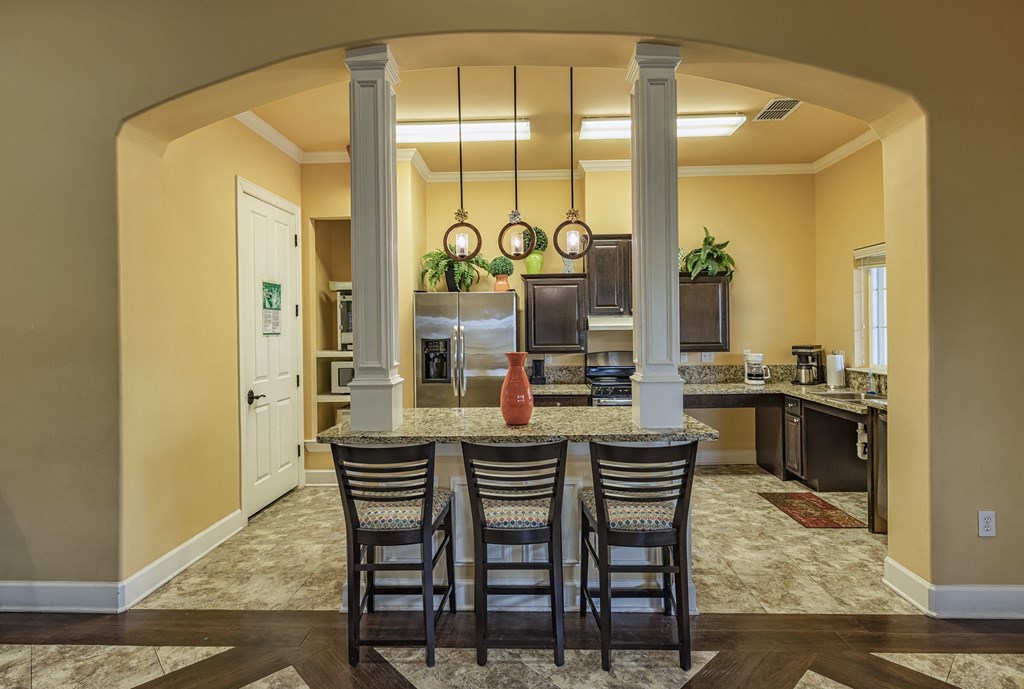 a kitchen with a marble counter top and a dining table