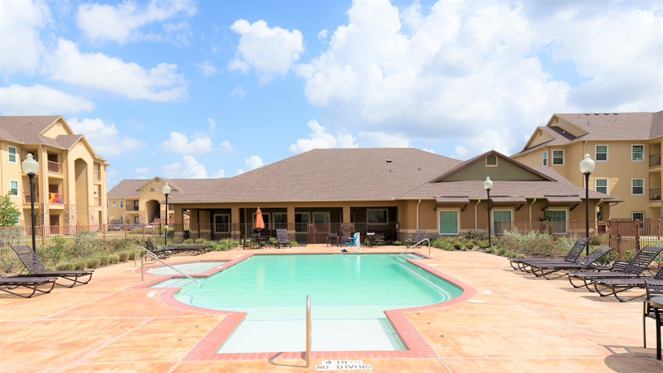 a swimming pool with a building in the background