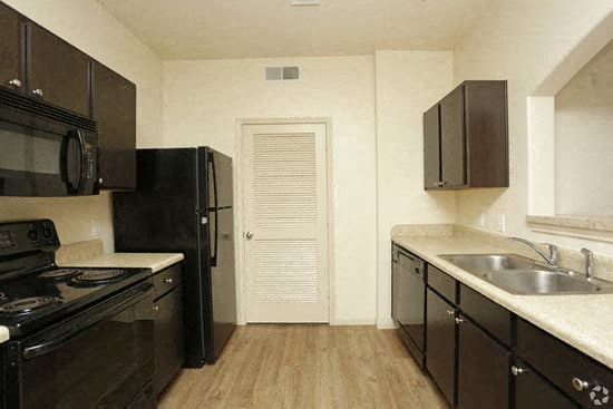a kitchen with a stove a sink and a refrigerator