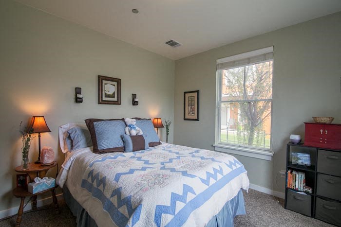 a bedroom with a large bed and a window