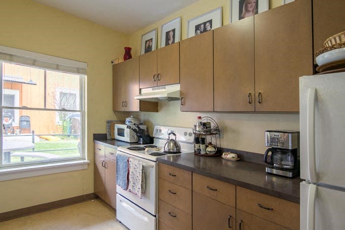 a kitchen with a stove and a refrigerator