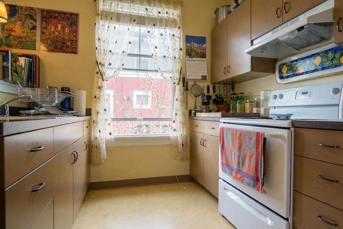 a small kitchen with a stove and a window