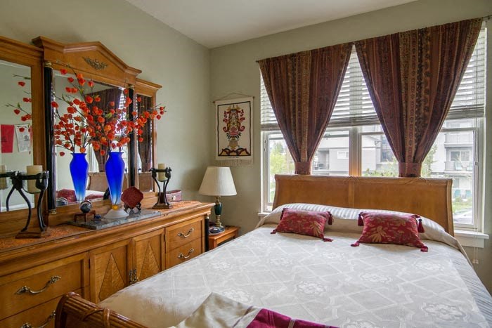 a bedroom with a large bed and a dresser