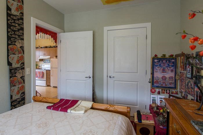 a bedroom with a large bed and two doors