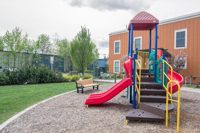 a playground with a slide and a bench