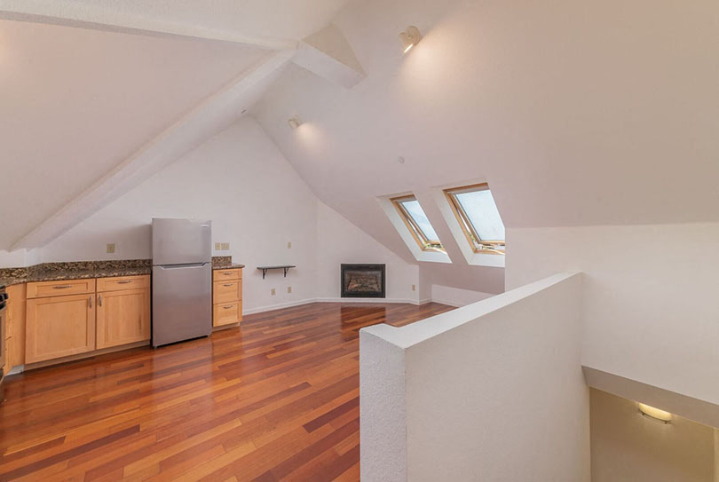 Kitchen and living area with windows and fireplace  l 132 Clay Street Apartments