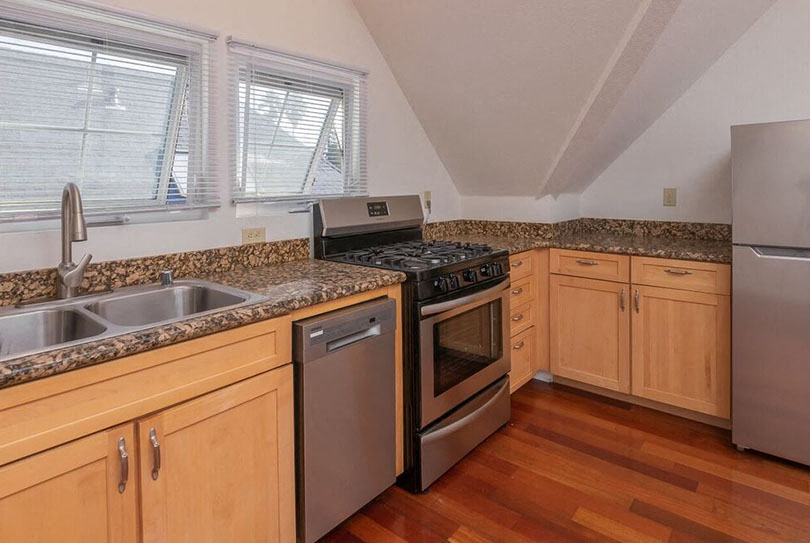 a kitchen with granite counter tops and stainless steel appliances