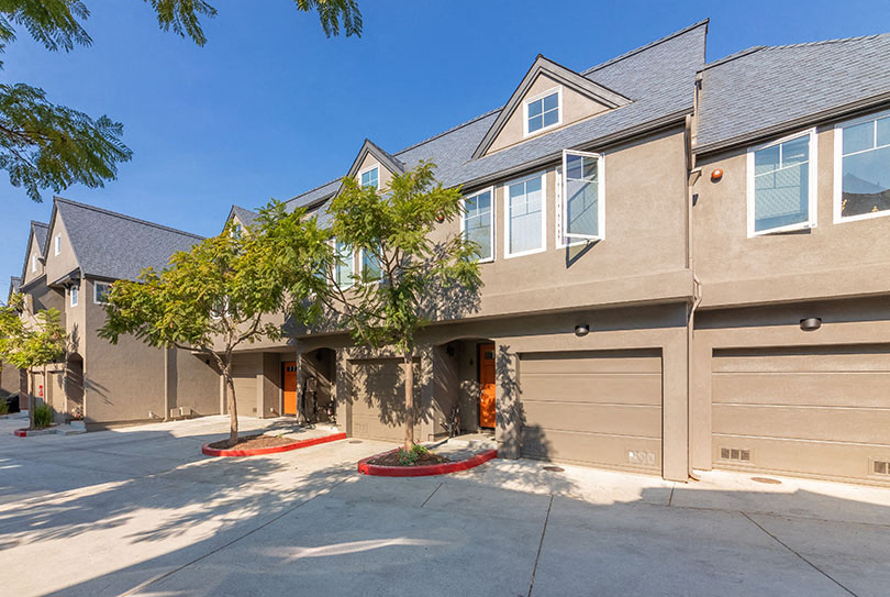 Exterior view of building with garages l 132 Claystreet Apartments