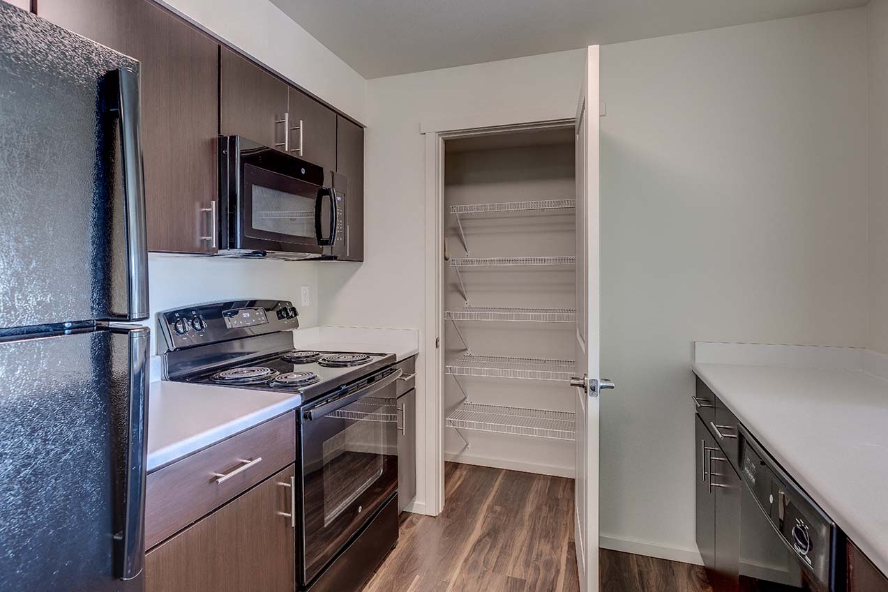 a kitchen with a stove and a refrigerator