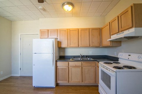 a kitchen with white appliances and wooden cabinets