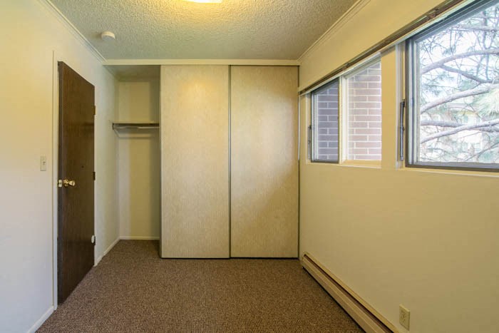 a room with a closet and a window and a door