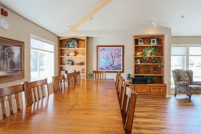 a large dining room with a wooden table and chairs