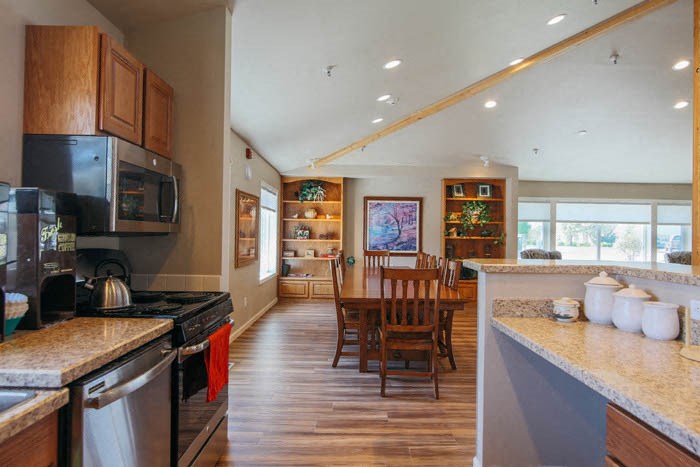 a kitchen and dining room with a table and chairs