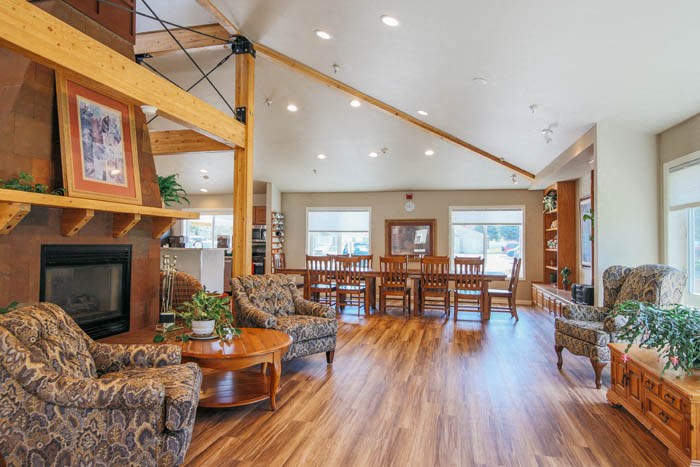 a living room with a fireplace and a table and chairs