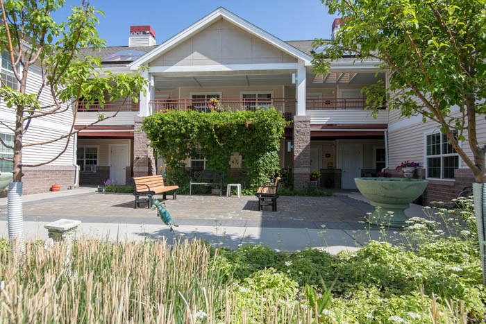 a house with a courtyard with benches and a fountain