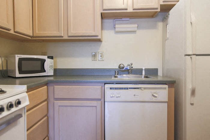 a kitchen with a stove microwave and sink