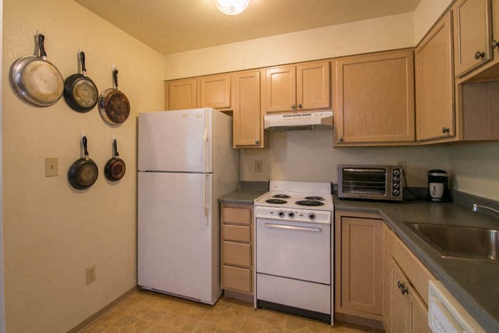 a kitchen with a stove and a refrigerator