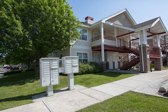 a white house with two mailboxes in front of it