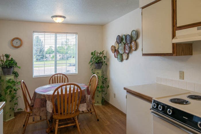 a kitchen with a table and chairs and a stove